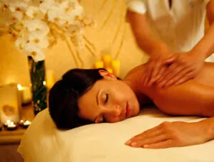 Calming back massage in a candlelit room